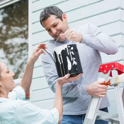 Volunteers painting a house.