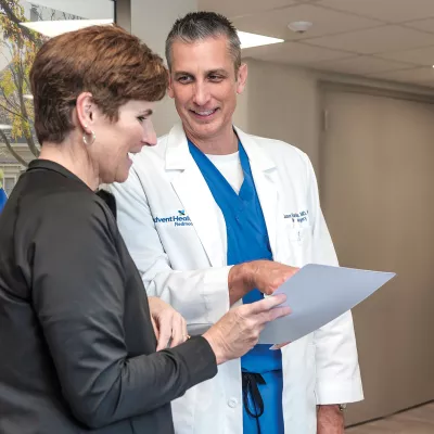 Neurosurgeon Jason Harrison, MD, PhD, with a patient