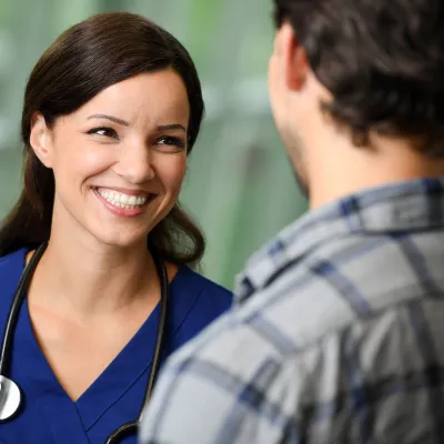 A nurse talking to a patient at the hospital.