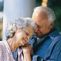a senior couple holding hands