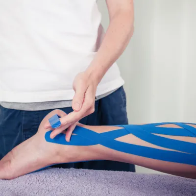 Physiotherapist applying kinesio tape