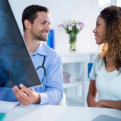 Physician showing information to patient