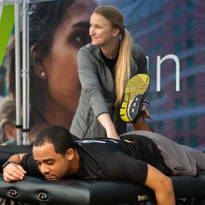 Sports Medicine professional working on runner's leg.