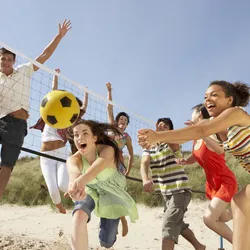 People playing volleyball on the beach