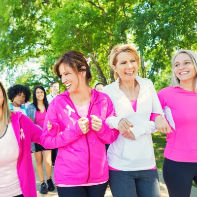 Women walking together outside for breast cancer awareness.