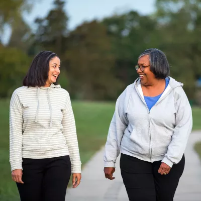 Two women taking a morning walk in the park.
