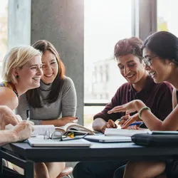young people sitting at a table