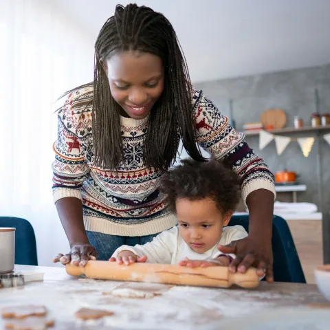 A mother and her daughter cooking holiday dinner together