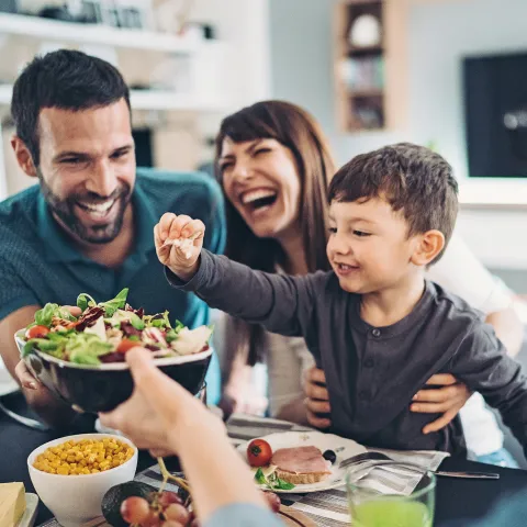 A Family Gathers Around The Kitchen Table To Enjoy Some Healthy Foods.