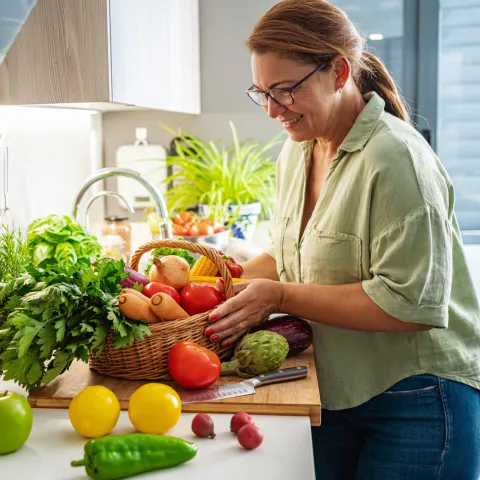 A Woman Prepares Vegetables in the Kitchen of Her Home