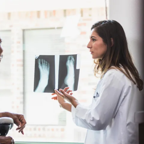 A Provider Goes Over a Foot X-Ray with Her Patient