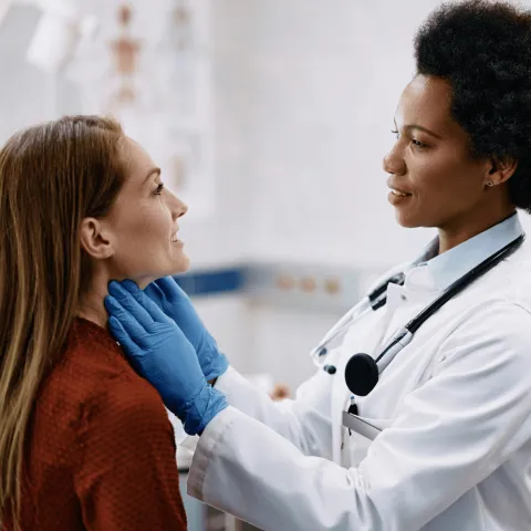 A Physician Checks Her Patient's Throat in a Practice Office.