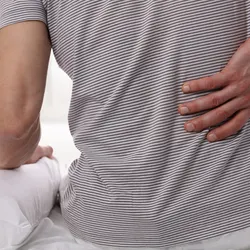 Man holding aching back.