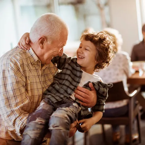 Grandfather playing with grandson.