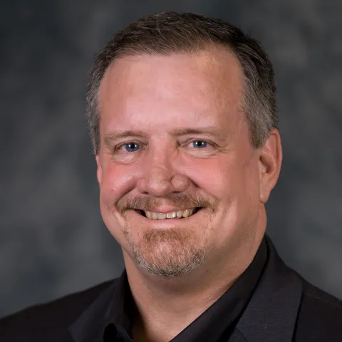 A Headshot of Author Roy Reid