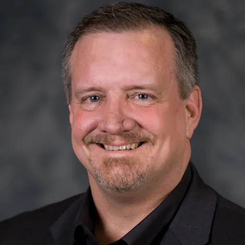 A Headshot of Author Roy Reid