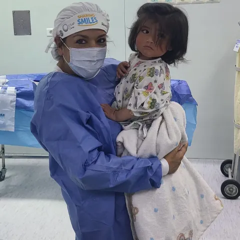 Maria Rodammer holding a child