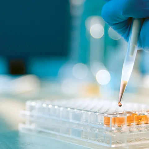 Hand dispensing liquid into a container