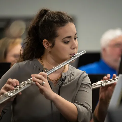 Erica Kopp practices with the AdventHealth employee orchestra.