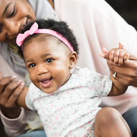 Teaching her little girl to stand.
