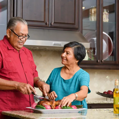 Couple cooking dinner together.