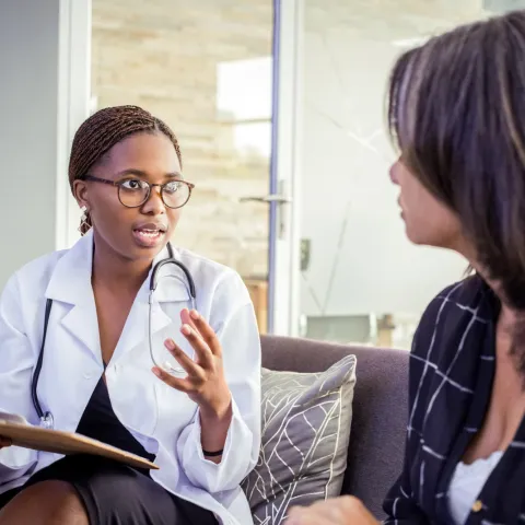 A woman talks with her doctor.