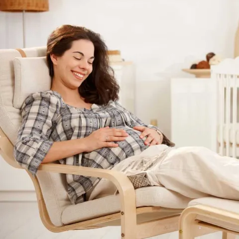 A mother relaxing in her future baby's room