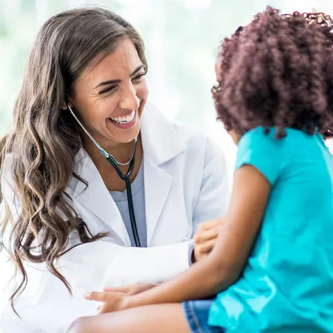 Doctor laughing with a young patient
