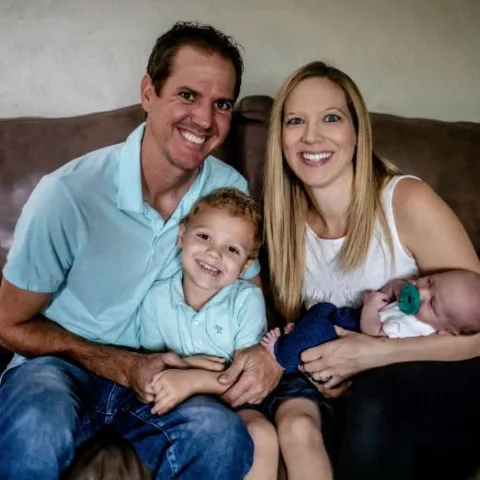 Lindsey F and her husband holding their children