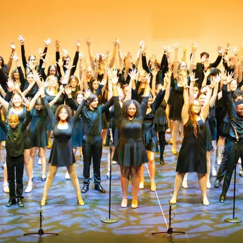 A group of people performing on stage.