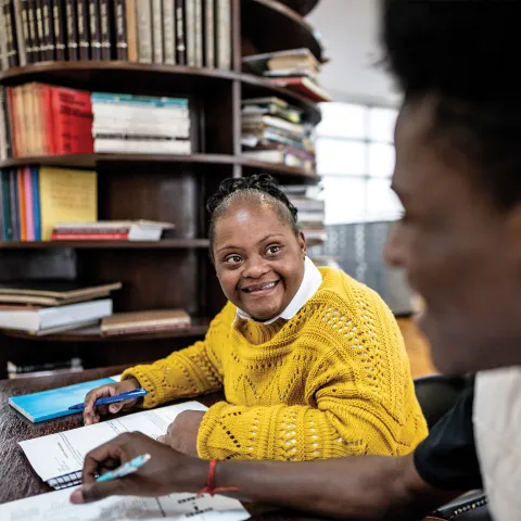 Woman with Down Syndrome working at a desk