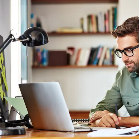 Young Man working on a laptop.