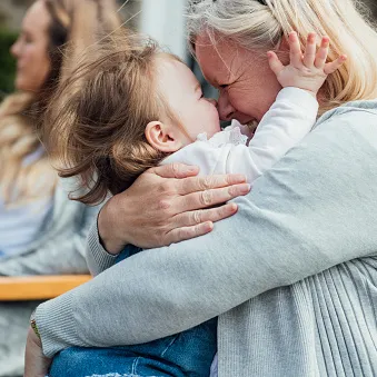 toddler and grandmother hugging