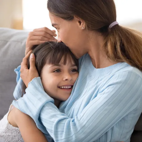 A mother hugs her child.