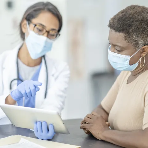 A woman at the doctor wearing a mask.