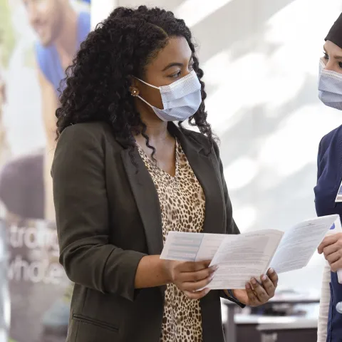 A woman checking in for a visit at AdventHealth. 