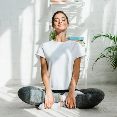 A woman taking a deep breath. 