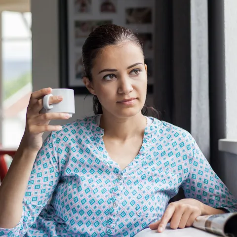 A woman sitting by the window.