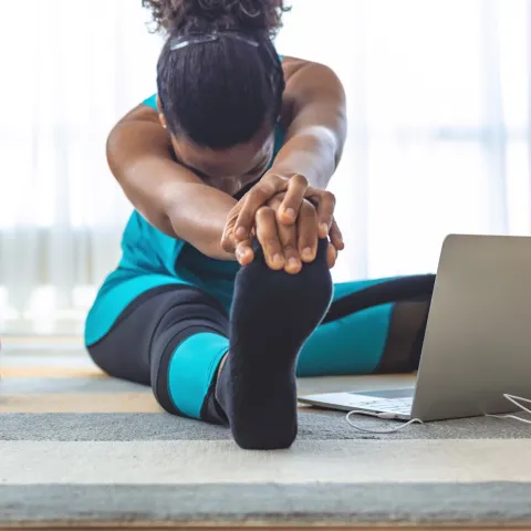 A woman stretching at home.