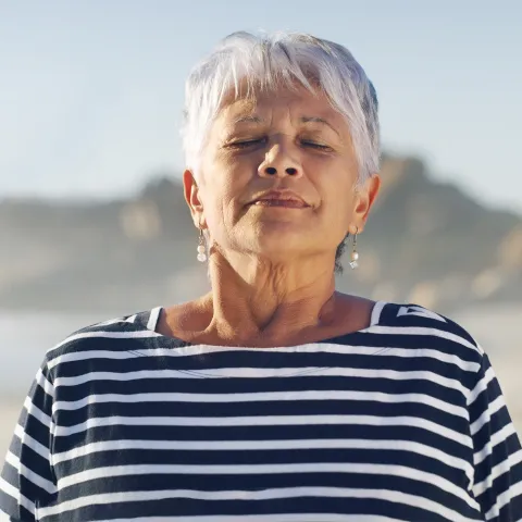 A woman taking a deep breath.