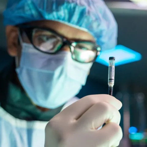 A doctor inspecting a vile