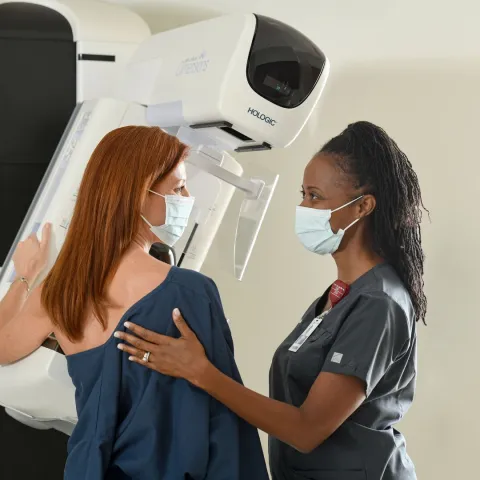 nurse helping patient with mammogram
