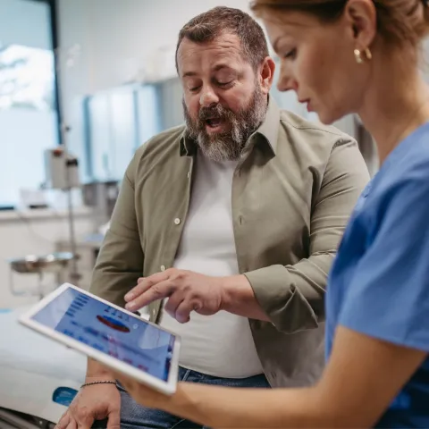 A male patient talks with a female doctor about his test results.