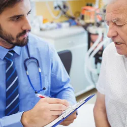 Physician speaking with male patient