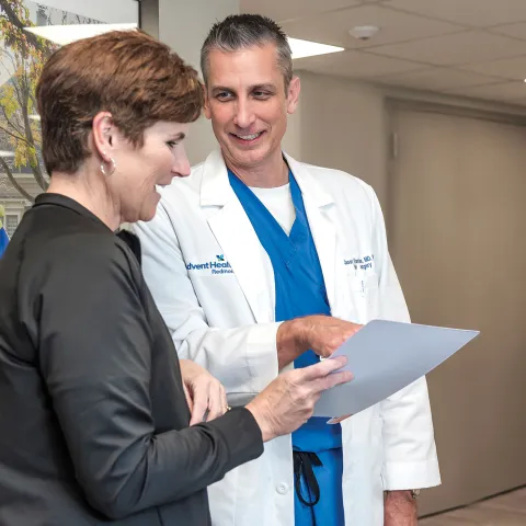 Neurosurgeon Jason Harrison, MD, PhD, with a patient