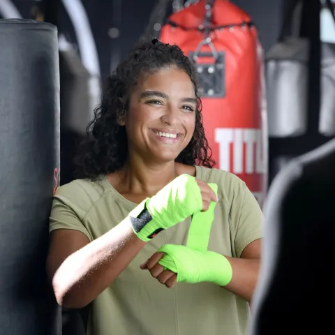 Sharlene wrapping her hands up with tape.