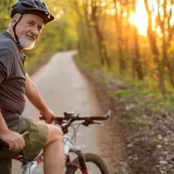 Man wearing safety helmet and preparing to go biking