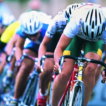 Cyclists biking downhill on a road
