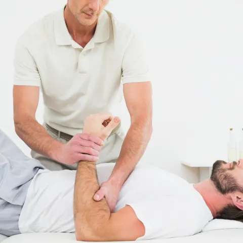 Athletic trainer helping athlete