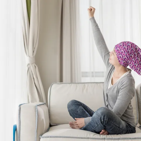 Cancer survivor stretching arm upwards
